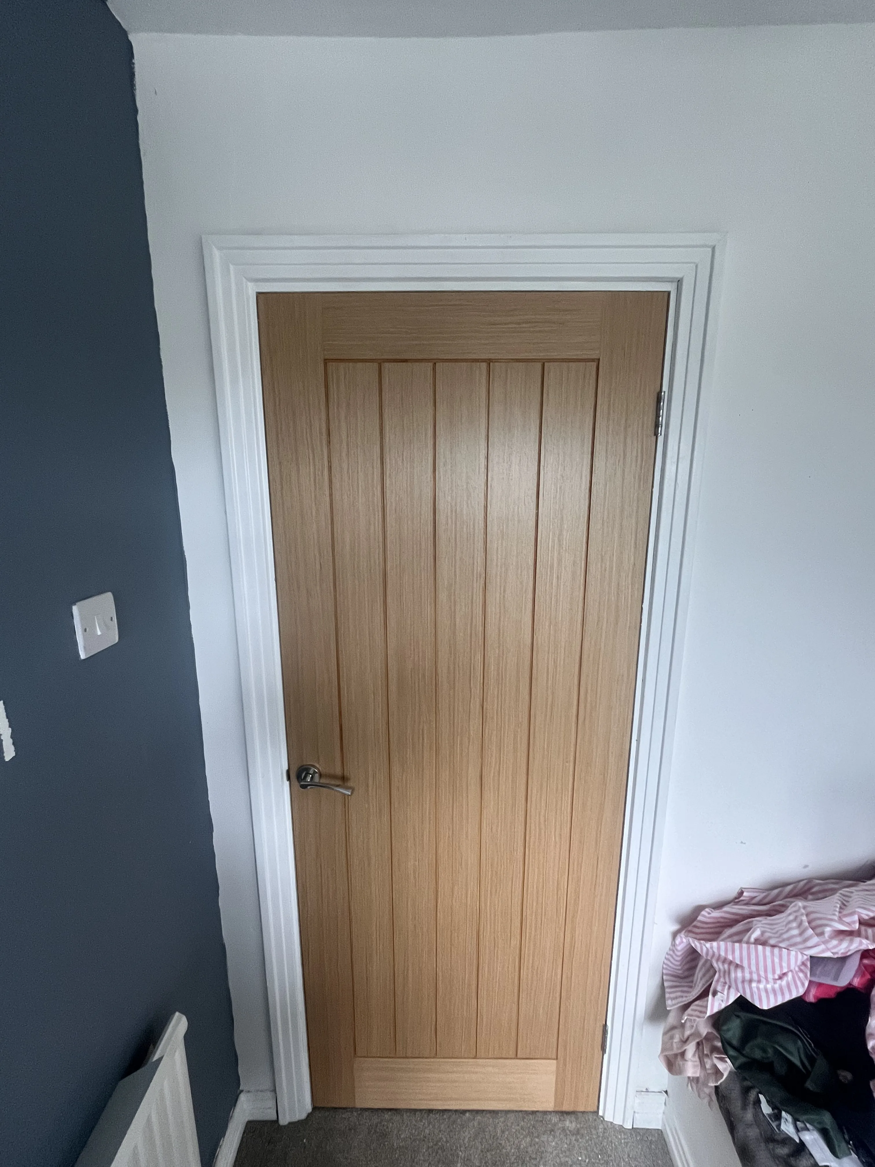 Oak internal door fitted with white architrave in Neath Port Talbot