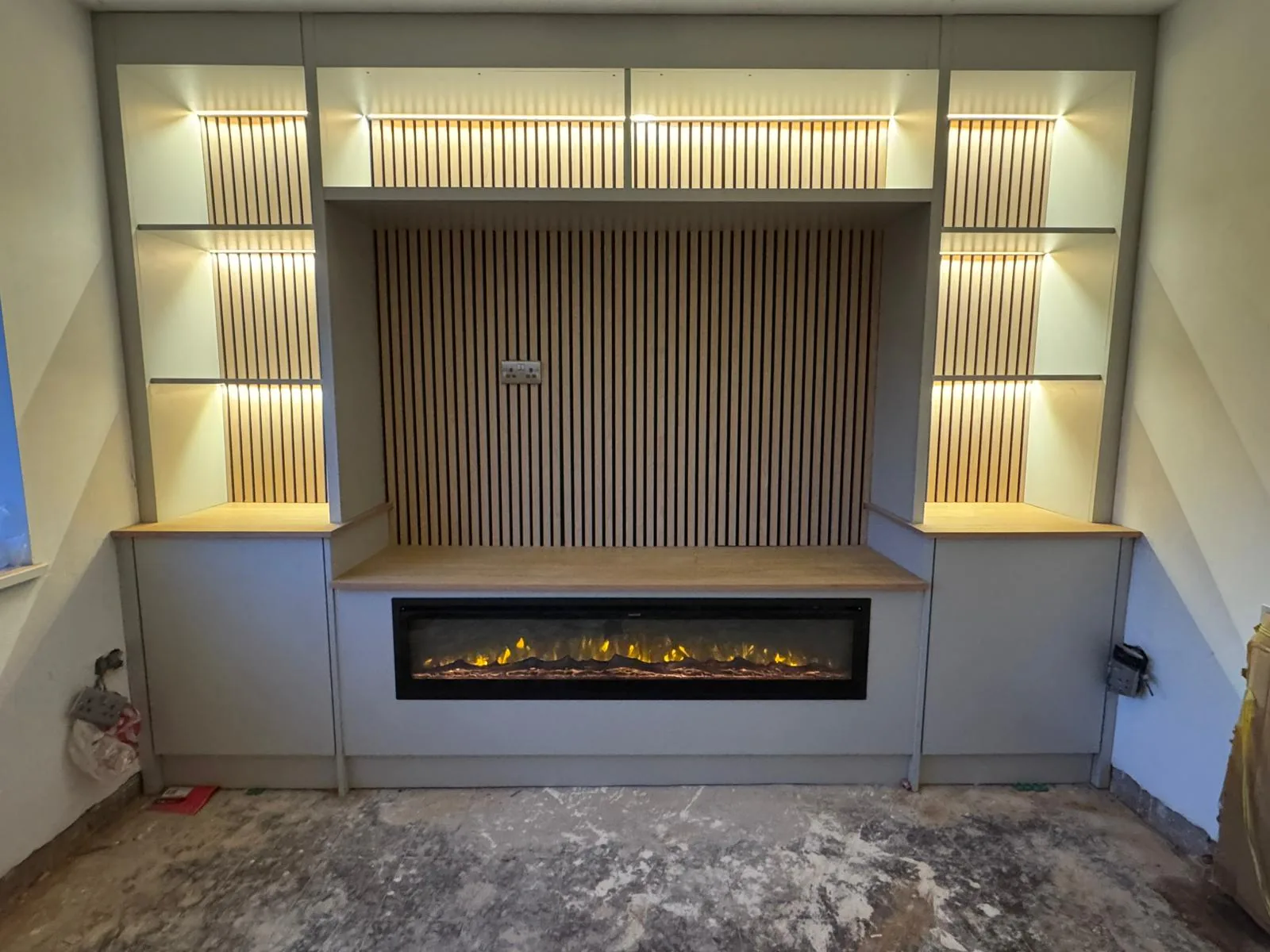 Bespoke media wall with oak slat feature and LED lighting in Neath